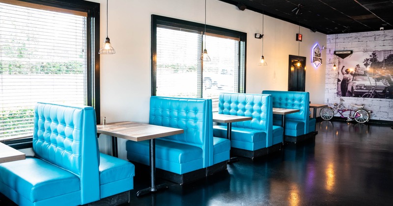 Interior, blue inline dining booths by windows