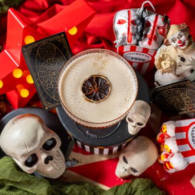 Ring of Fire cocktail surrounded by decorative miniature skulls.