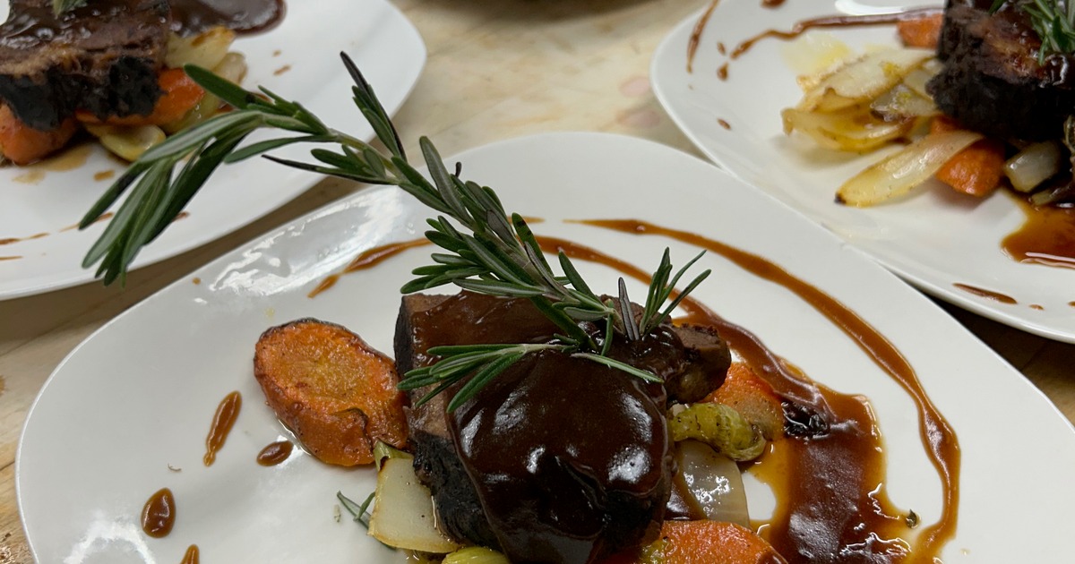 Braised beef served with roasted root vegetables and a dark reduction sauce
