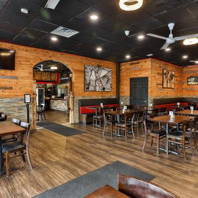 Interior with wood-paneled walls and booth and table seating.