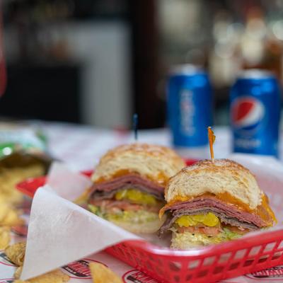 The Manwich sandwich with hot pastrami, roast beef, cheese, pickles, and lettuce.
