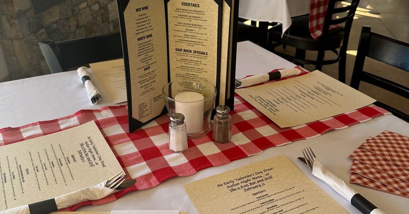 A dining table setting with menus