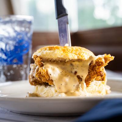 Fried chicken biscuit sandwich with American cheese and house gravy.
