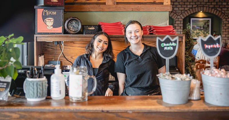 Restaurant interior, two people behind the counter