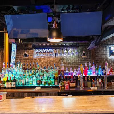 Bar area featuring a well-stocked bar counter with various liquor bottles.