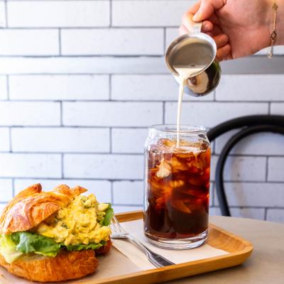 Croissant sandwich with scrambled eggs and iced coffee.
