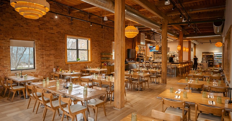 Restaurant interior, dining area and bar area, dining tables lined up