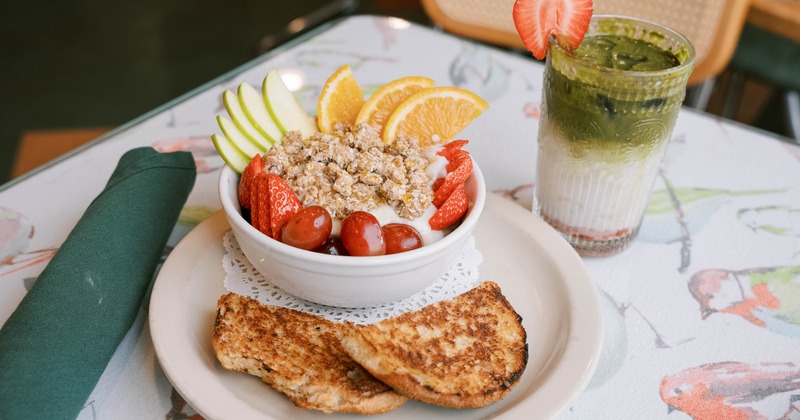 Fruit and granola bowl with a drink
