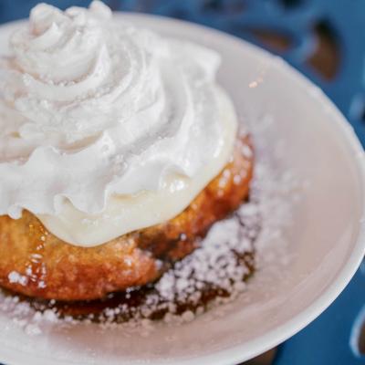 Fried cinnamon bun, served, front view, closeup