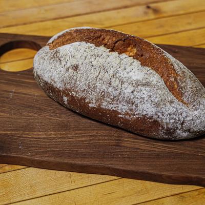 A loaf of bread on a wooden board.