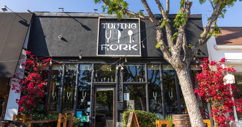 Exterior, front view to the restaurant entrance and side garden with tables and chairs