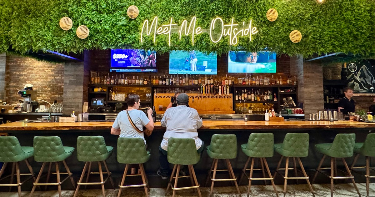 Modern restaurant interior featuring a wooden table with teal chairs