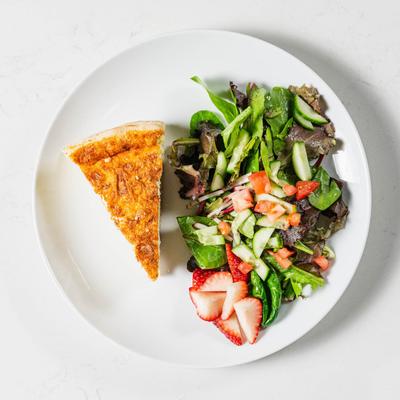 Quiche with bacon and gruyere cheese, with a side salad.