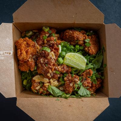 Chicken nuggets served in a paper box.