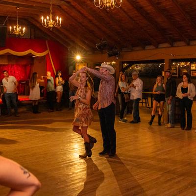 A couple dancing on the floor.