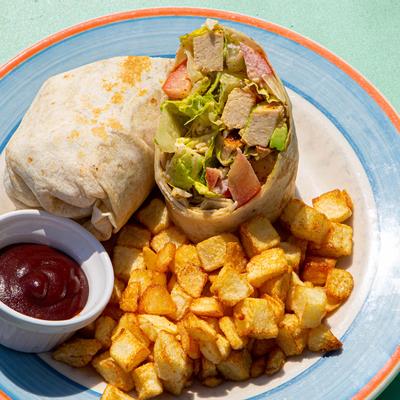 Burritos, baked potato and dip on the side