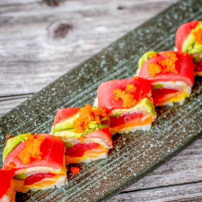 Tuna, salmon, and yellowtail sushi rolls, topped with tuna, avocado, and roe.