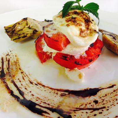 Grilled tomatoes, cheese, and artichokes.