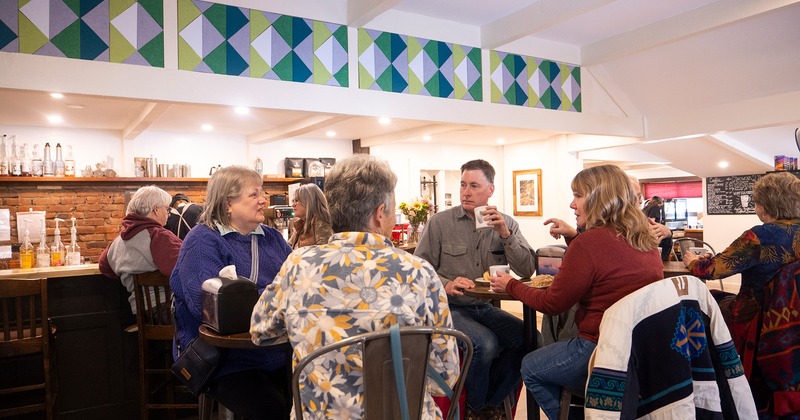 Interior, seating area, guests chatting and enjoying their food and drinks