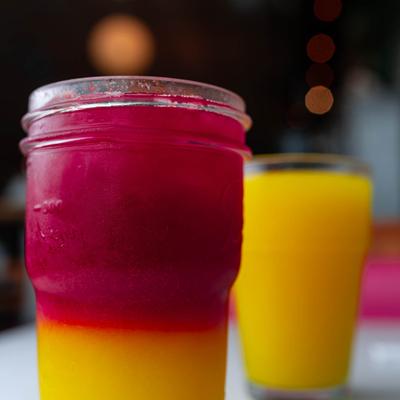 Red-yellow drink served alongside a yellow beverage.