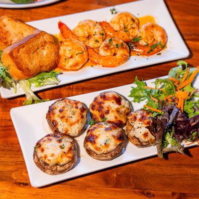 Crab stuffed mushrooms and shrimp appetizers, served, top view.