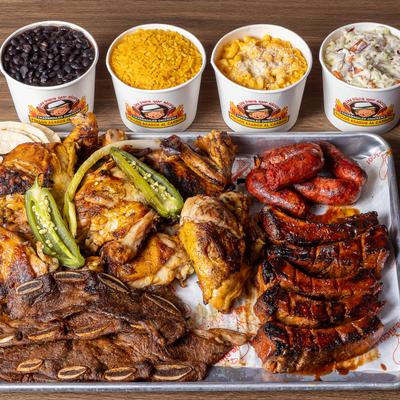 Large family platter featuring various grilled meats served alongside traditional sides.