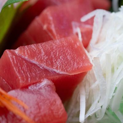 Close up of tuna sashimi arranged with thinly shredded daikon radish.