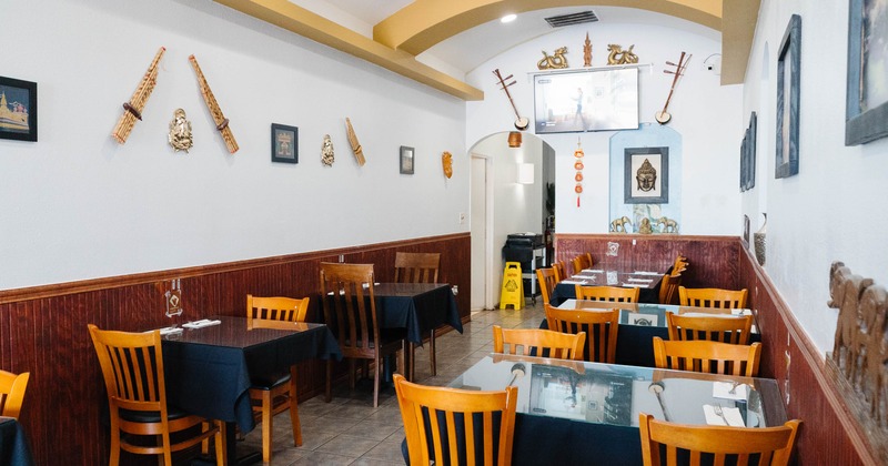 Interior, dining area, tables with wooden chairs, tile flooring