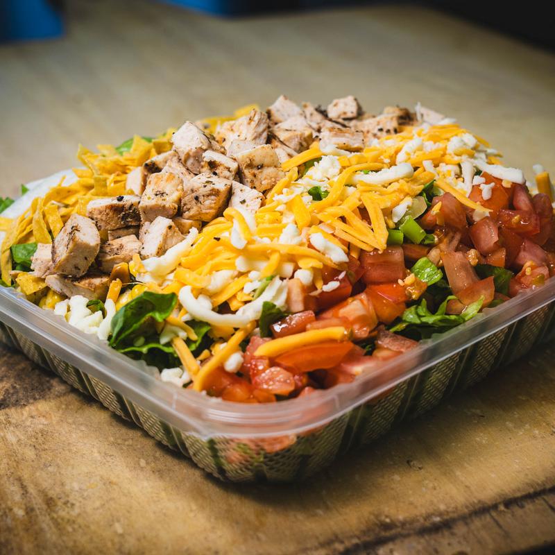 Mixed vegetables and chicken salad topped with cheese