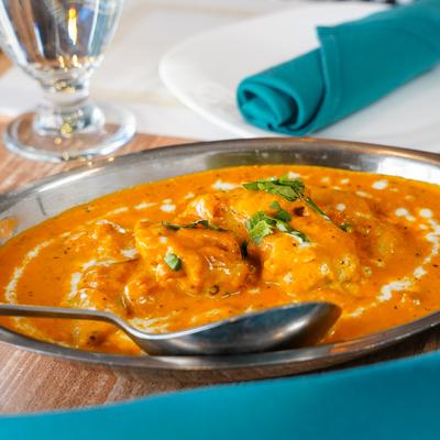 Chicken with onion, cream gravy, nuts, raisins, and spices.