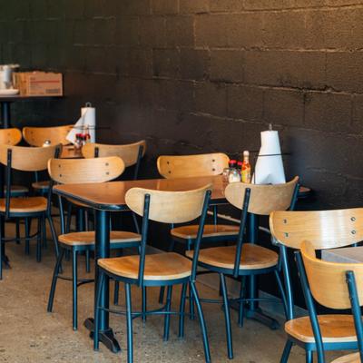 Interior with industrial-style metal chairs with wooden seats and backrests and matching tables.
