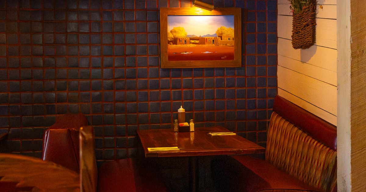 Interior, corner seating area, seating booth with wooden top table, ready for guests
