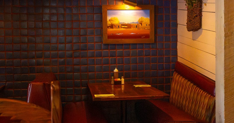 Interior, corner seating area, seating booth with wooden top table, ready for guests