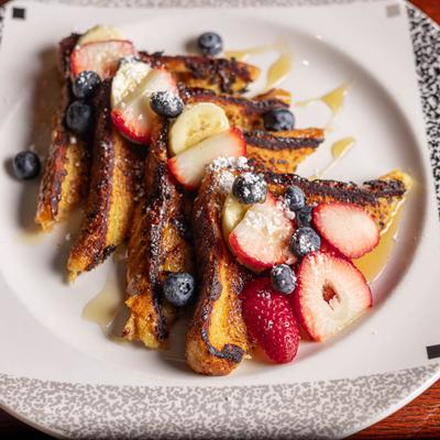 French Toast, with sliced bananas, and berries.