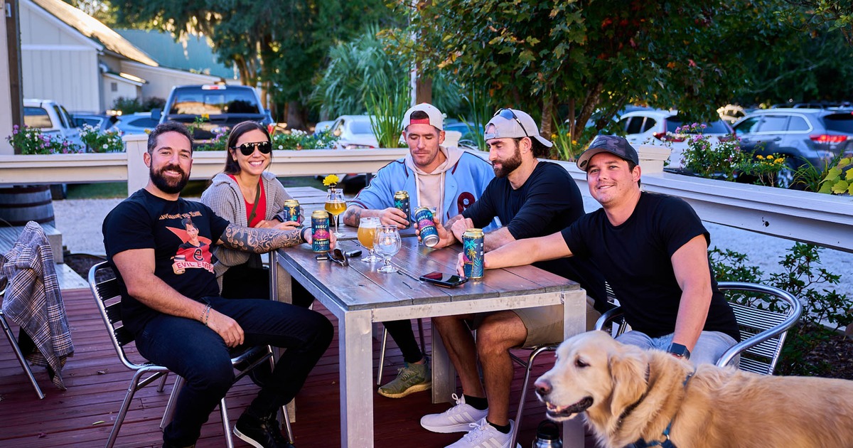 Customers with a dog, drinking beer