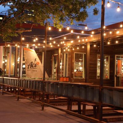 Patio, string lights, restaurant signage'.