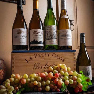 Various wine bottles and fresh grapes.