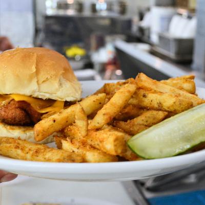 Fried chicken sandwich, served with fries.
