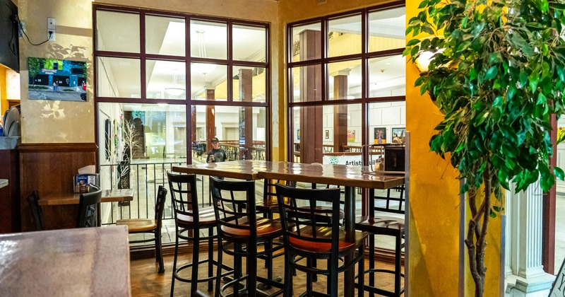 Interior, tables and stools near the window