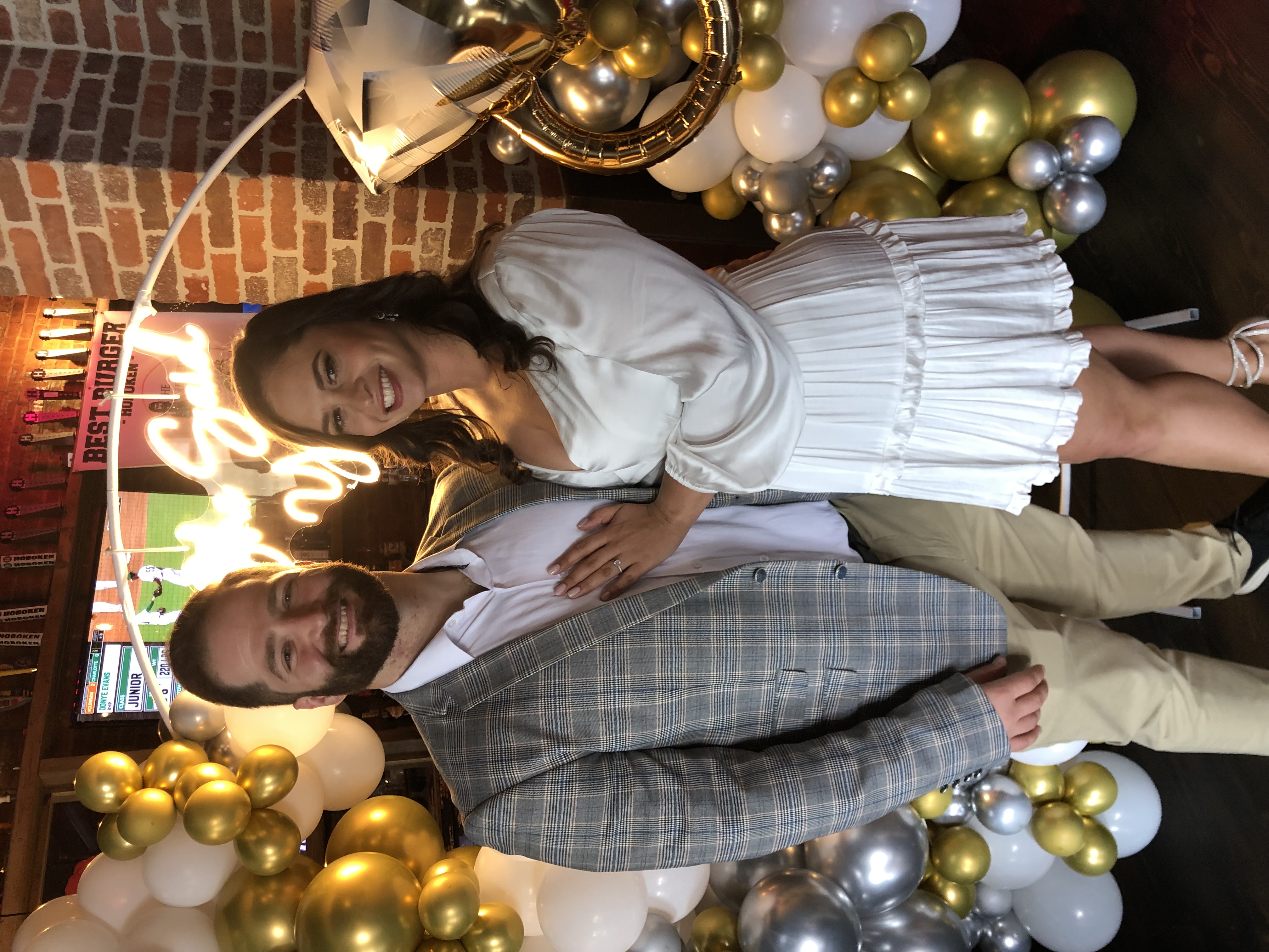 couple celebrating engagement party at the bar