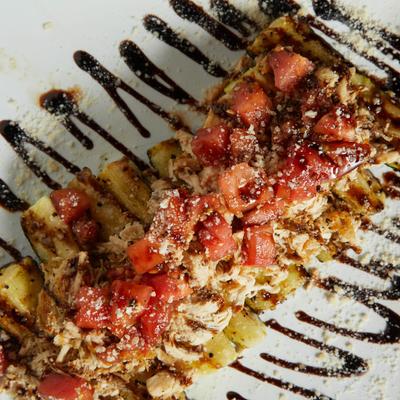 Grilled Zucchini topped with homemade bruschetta and a sprinkle of Parmesan.