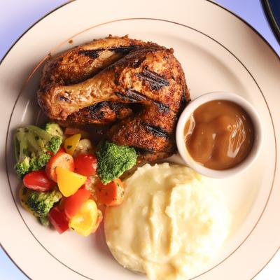 Mediterranean Roast Chicken with mashed potato, roasted vegetables & gravy.