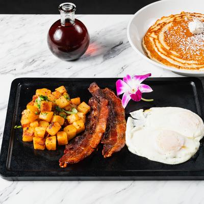 The Breakfast Combo, wine and pancakes on a table.
