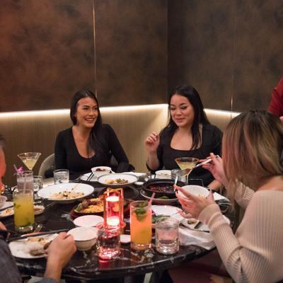 A group of guests enjoying meal and drinks.