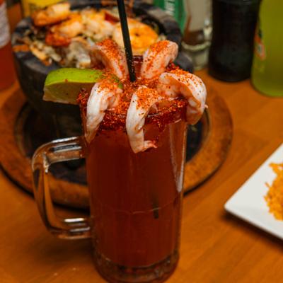 Michelada cocktail garnished with shrimp.