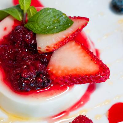 Panna cotta with mixed berries, close up.