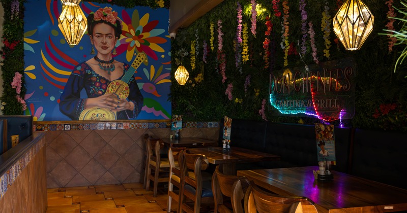 Cozy seating with a Frida Kahlo mural and floral decor