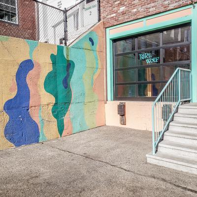 Exterior, front entrance, graffiti on the wall.