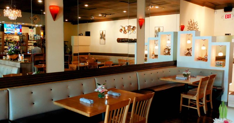 two booths next to a mirrored wall