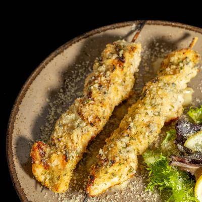 Two chicken skewers coated in Parmesan-herb breadcrumbs.